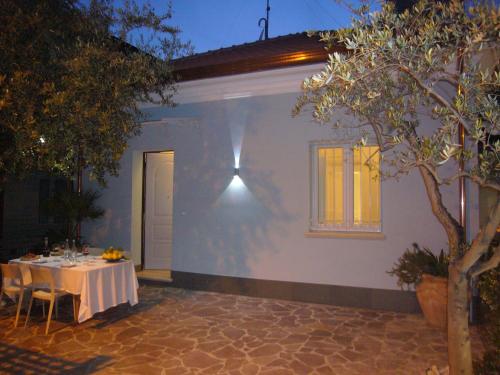 a table in front of a house at night at Residence Diffuso Arcobaleno in Gabicce Mare