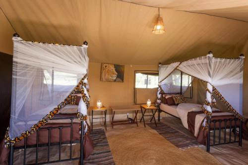 Ένα ή περισσότερα κρεβάτια σε δωμάτιο στο Gnu Mara River Camp