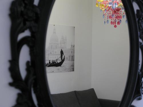 a mirror with a picture of a boat in the water at Apartamentos El Templo Suites in Merida