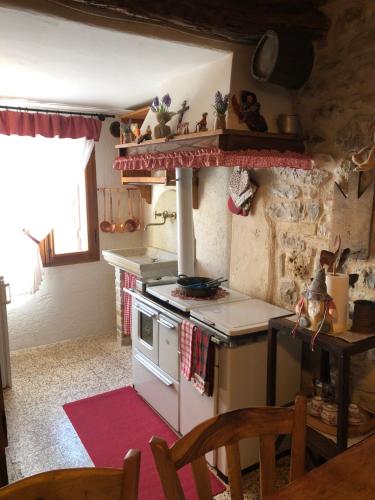 a kitchen with an oven and a table and chairs at CASA ANGELA Stayerat a SEGUSINO Valdobbiadene in Segusino
