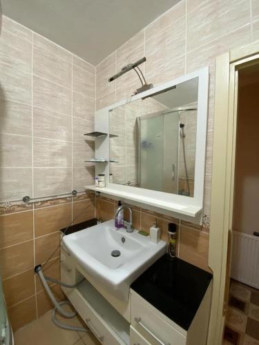 a bathroom with a white sink and a mirror at Private Room in Istanbul #47 in Pendik