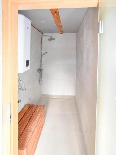 a bathroom with a shower and a wooden floor at Spa Oasis Samanta in Ludbreg