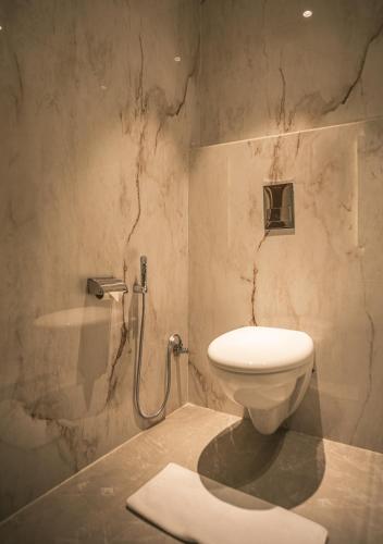 a bathroom with a toilet and a sink at Amritara Kirpa, Amritsar in Amritsar