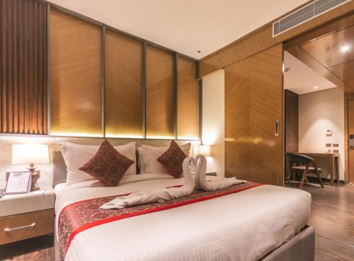 a hotel room with a bed with shoes on it at Amritara Kirpa, Amritsar in Amritsar