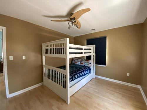 Letto a castello bianco in camera con ventilatore a soffitto di 3 bedroom Atlantic City House Steps from Boardwalk, beach, shopping , nightlife. ad Atlantic City
