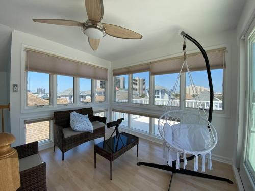 a living room with a couch and a swing at 3 bedroom Atlantic City House Steps from Boardwalk, beach, shopping , nightlife. in Atlantic City
