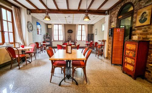 een eetkamer met tafels en stoelen in een restaurant bij Hotel De Schacht in Genk