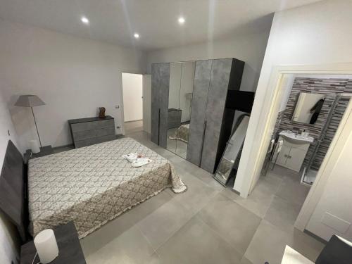 a bedroom with a bed and a large mirror at Be Home in Matera