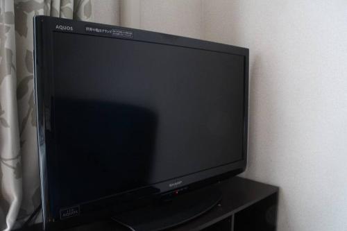 a flat screen tv sitting on top of a table at First Hiroshima in Hiroshima