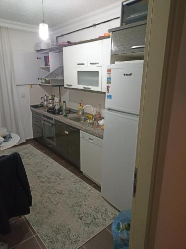 a kitchen with white cabinets and a white refrigerator at Private Room in Istanbul #49 in Tuzla