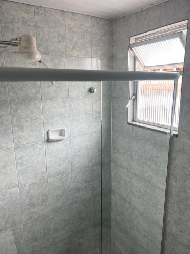 a bathroom with a shower with a glass door at Hotel Buriti da Serra in Itaipava