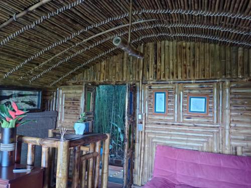 a room with a couch and a wooden wall at Finca Colibrí Zafiro, Altos del Rosario in Cali