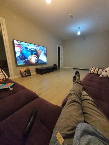 a person laying on a couch watching a tv at Private Room in Istanbul #50 in Tuzla
