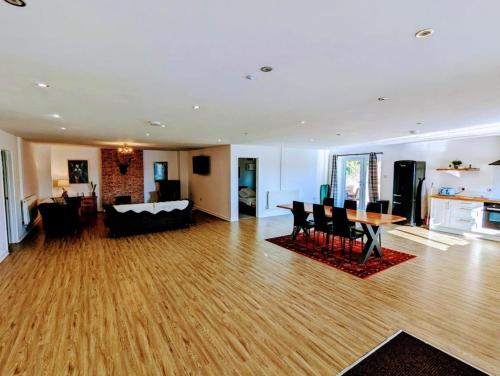 a living room with a couch and a table at Country Lodge Retreat in Lydney