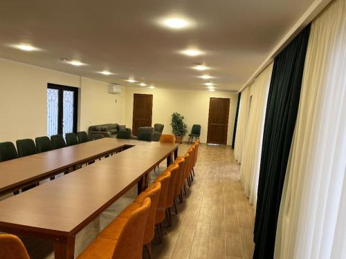 a conference room with long tables and chairs and curtains at Family Hotel Lago & Wine Cellar in Lagodekhi