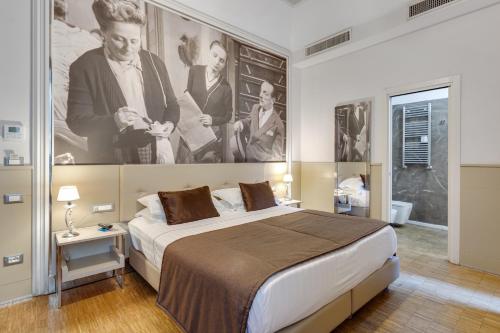 a bedroom with a large bed with a large painting on the wall at Partenope Relais in Naples