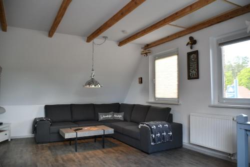 a living room with a couch and a table at Balders Bude 2 in Mönkebude