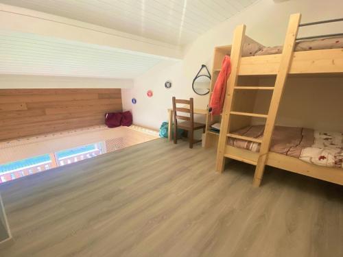 a room with two bunk beds and a pool at Appartement rénové avec mezzanine et balcon au cœur de Samoëns, idéal pour famille nombreuse - FR-1-624-69 in Samoëns
