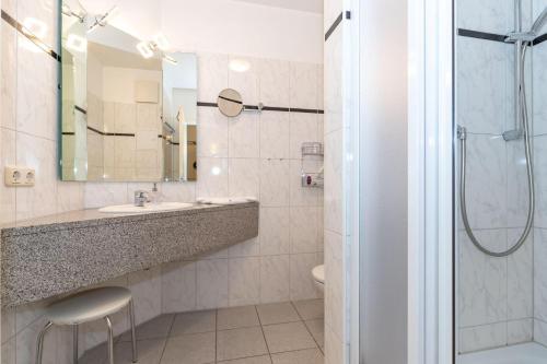 a bathroom with a sink and a shower at Haus-Ostseewelle-Wohnung-13-312 in Kühlungsborn