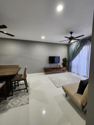 a living room with a ceiling fan and a couch at Little Sofia's Cottage in Kajang