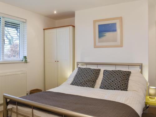 a bedroom with a bed and a window at High View in Truro