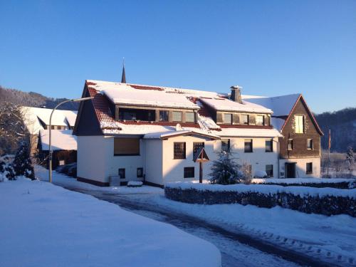 a house covered in snow with a street light at fun4all-holidayhome in Medebach