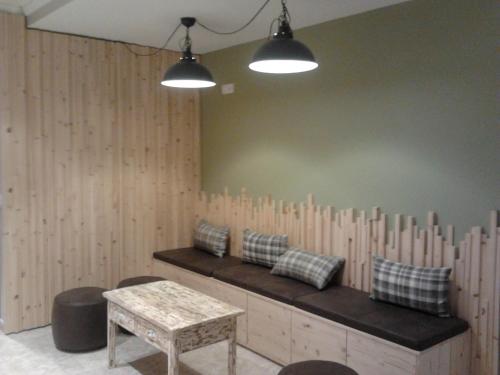 a room with a bench with pillows and a table at Guilleumes Montserrat in Monistrol