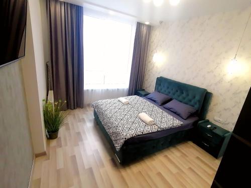 una camera da letto con un letto con cuscini viola e una finestra di Новобудова Сам центр вул Шевченка 60 Оперний 10хв a Lviv