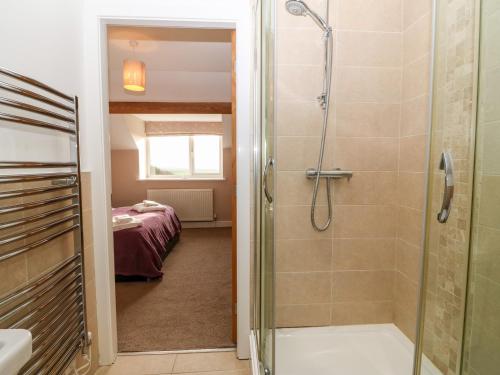 a bathroom with a shower and a walk in shower at Ty Top in Llanfaethlu