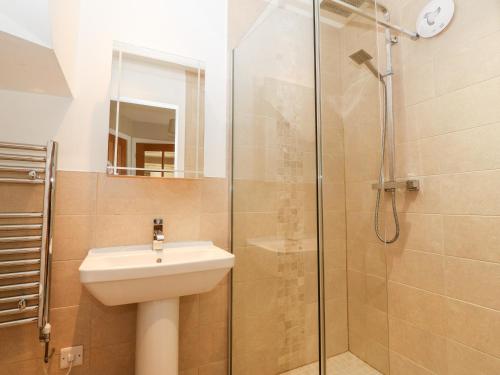 a bathroom with a sink and a shower at Ty Top in Llanfaethlu