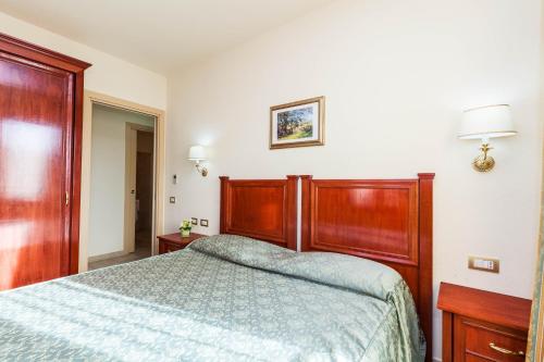 1 dormitorio con 1 cama con edredón azul en Regina Elena Apartments en Olbia