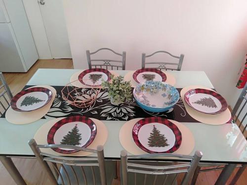 a dining room table with plates on it at Avida 3-Bedroom Vacation House with Pool in Minuluang