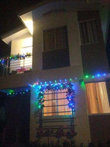 a house with christmas lights on the front of it at Avida 3-Bedroom Vacation House with Pool in Minuluang