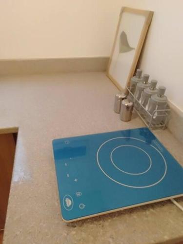 a blue board sitting on the floor next to a mirror at Avida 3-Bedroom Vacation House with Pool in Minuluang