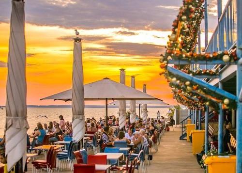 a crowd of people sitting on a pier at the beach at One-bed apartment at Darwin Waterfront Precinct in Darwin