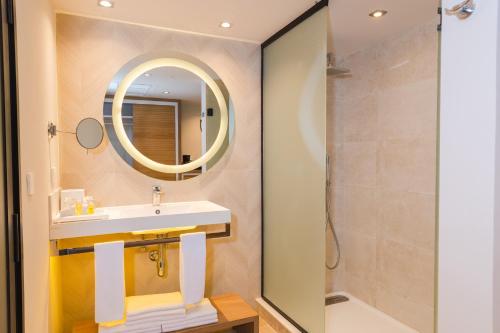 a bathroom with a sink and a mirror and a shower at Bahia Principe Luxury Akumal - All Inclusive in Akumal