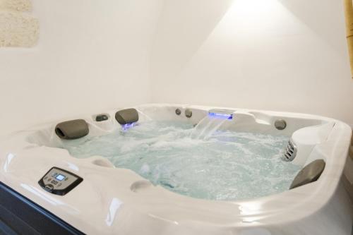 a white bath tub with water in it at Ostuni Luxury Room in Ostuni