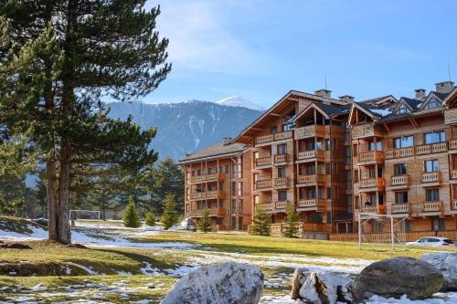 a large apartment building in the mountains with snow at Kate's apartment in Pirin in Razlog