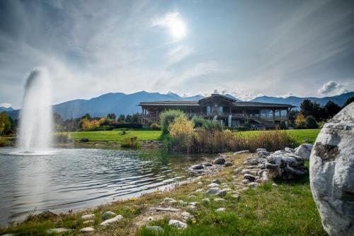 a house next to a lake with a fountain at Kate's apartment in Pirin in Razlog