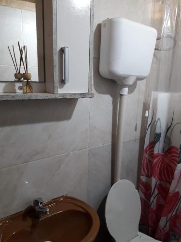 a bathroom with a sink and a toilet and a mirror at Macrigaluma Luna solo con seña in Barra del Chuy