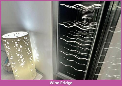 a wine fridge with a glass in front of it at Park View On Bayswater | 2 Storey Townhouse in Aitkenvale