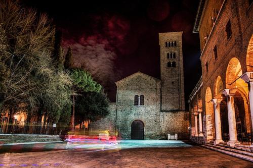 an old church with a clock tower at night at BB LETTERARIO in Ravenna