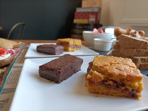 a table with several different types of cakes on plates at BB LETTERARIO in Ravenna