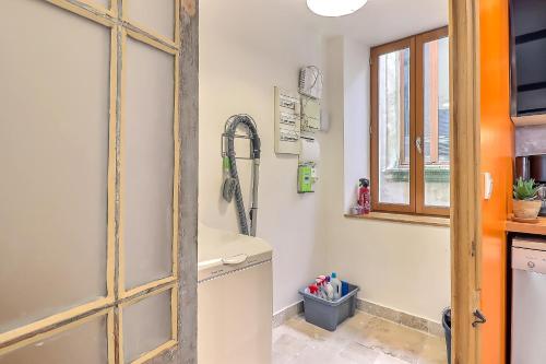 a kitchen with a sink and a dishwasher at Appartement Garance in Nîmes