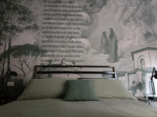 a bedroom with a bed with a scripture wall mural at BB LETTERARIO in Ravenna