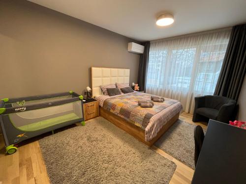a bedroom with a large bed and a large tv at CityApartment in Sofia