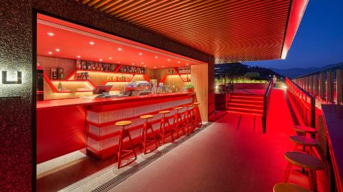 a restaurant with a bar with red lighting at Hotel Indigo Alishan by IHG in Fanlu