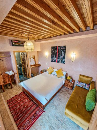 a bedroom with a large bed and a couch at Riad El Pacha in Rabat
