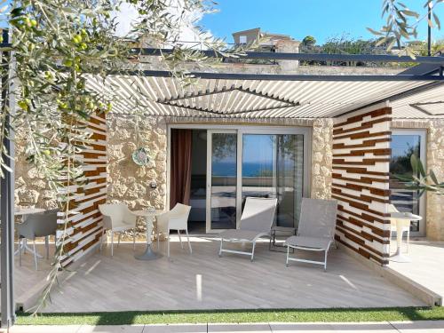 a patio with a table and chairs on a deck at Daedalium in Marina di Palma