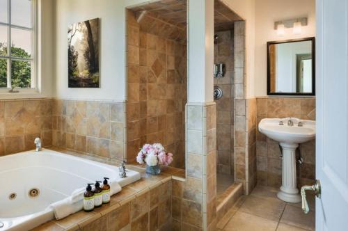 a bathroom with a tub and a sink at Seal Cove Inn in Half Moon Bay